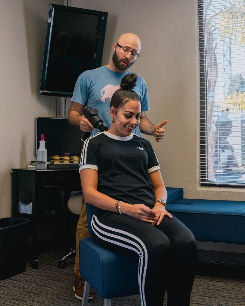 Friendly chiropractor and patient at Vista clinic